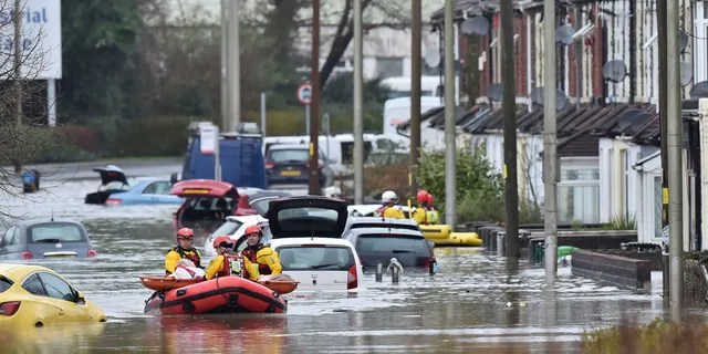 A member of the public is rescued after flooding in Nantgarw, Wales, Sunday, Feb. 16, 2020.