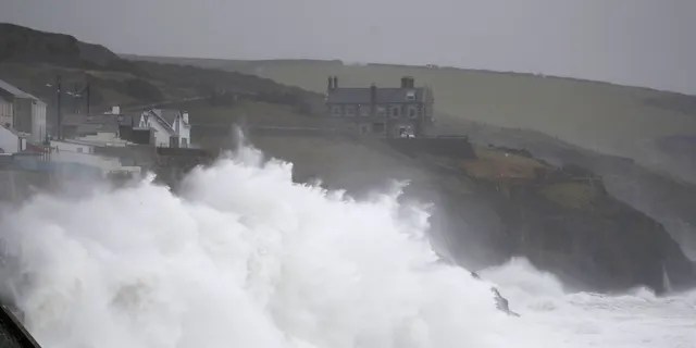 Powerful waves break on the shoreline around the small port of Porthleven, south west England, Sunday, Feb. 16, 2020.