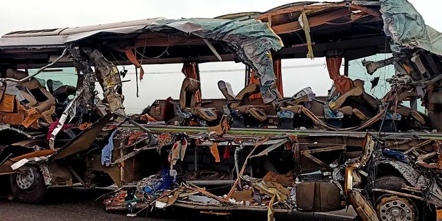 The remains of a Kerala state-run bus that collided head-on with a truck near Avanashi, Tamil Nadu state, India, Thursday, Feb. 20, 2020. At least 19 people were killed and more than 20 were injured in the accident. (AP Photo)
