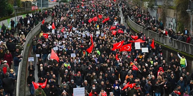 Thousands of people take part in a funeral march in Hanau, Germany, Sunday, Feb. 23, 2020. 