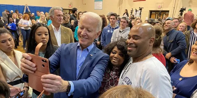 Former Vice President Joe Biden takes selfies with voters at a town hall in Conway, SC on Feb. 27, 2020