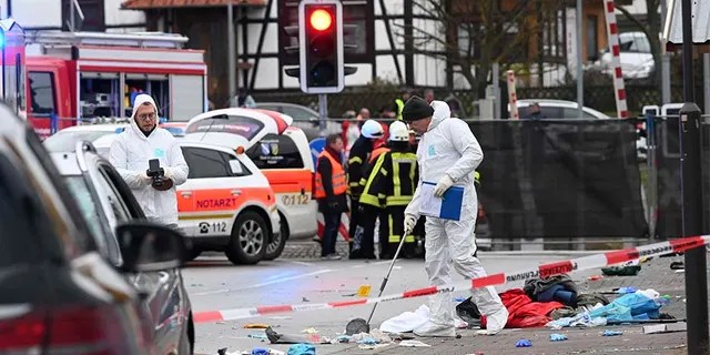 Police and rescue workers stand next to the scene of the incident in Volkmarsen, Germany, on Monday.