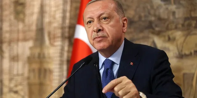 Turkey's President Recep Tayyip Erdogan speaks to his ruling party's lawmakers, in Istanbul, Saturday, Feb. 29, 2020. Erdogan said Saturday that his country's borders with Europe were open, as thousands of refugees gathered at the frontier with Greece.(Presidential Press Service via AP, Pool)