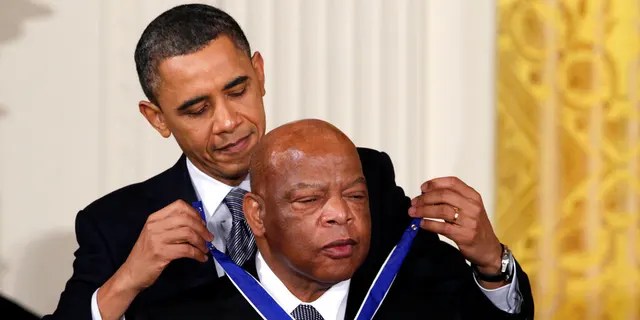 FILE - In this Feb. 15, 2011, file photo, President Barack Obama presents a 2010 Presidential Medal of Freedom to U.S. Rep. John Lewis, D-Ga., during a ceremony in the East Room of the White House in Washington. (AP Photo/Carolyn Kaster, File)