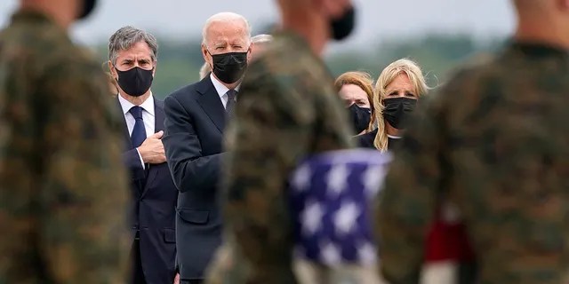 President Joe Biden, first lady Jill Biden, and Secretary of State Antony Blinken look on as as a carry team moves a transfer case with the remain of Marine Corps Cpl. Humberto A. Sanchez, 22, of Logansport, Ind., during a casualty return at Dover Air Force Base, Del., Sunday, Aug. 29, 2021, for the 13 service members killed in the suicide bombing in Kabul, Afghanistan, on Aug. 26. 