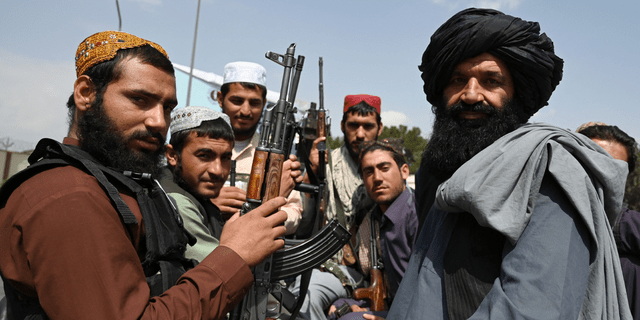 Taliban fighters sit on the back of a pick-up truck at the airport in Kabul on Aug. 31, 2021. (Getty Images)