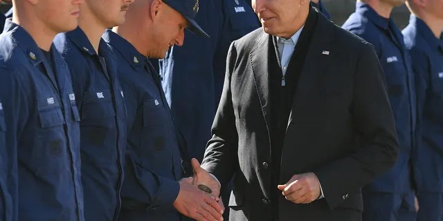 US President Joe Biden hands a service member a challenge coin as he greets members of the Coast Guard at US Coast Guard Station Brant Point in Nantucket, Massachusetts on November 25, 2021. - Biden is in Nantucket to spend the Thanksgiving holiday. (Photo by MANDEL NGAN / AFP) (Photo by MANDEL NGAN/AFP via Getty Images)
