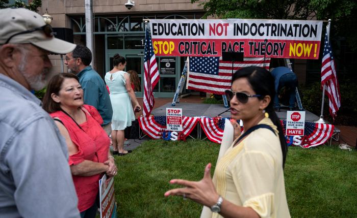 People talk before the start of a rally against "critical race theory" (CRT) being taught in schools at the Loudoun County Government center in Leesburg, Virginia on June 12, 2021. - "Are you ready to take back our schools?" Republican activist Patti Menders shouted at a rally opposing anti-racism teaching that critics like her say trains white children to see themselves as "oppressors." (Getty Images)