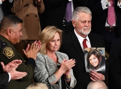 Carl and Marsha Mueller, among the special guests at President Trump’s State of the Union address on February 4, 2020, hold up a picture of their daughter, Kayla. (Photo by B