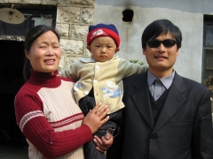 A picture dated March 2005 shows Chen Guangcheng with his wife and son outside their home in Shandong province. (Photo by STR/AFP via Getty Images)