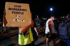A protester holds a placard during a demonstration against the shooting of Jacob Blake in Kenosha, Wisconsin on August 26, 2020. (Photo by KAMIL KRZACZYNSKI/AFP via Getty Images)