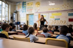 A teacher lectures the class. (Photo credit: MARTIN BUREAU/AFP via Getty Images)