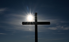 A cross stands against the sky. (Photo credit: CHRISTOF STACHE/AFP via Getty Images)