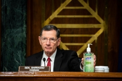 Senator John Barrasso, a Republican from Wyoming and chairman of the Senate Environment and Public Works Committee, places a bottle of hand sanitizer on the dais during a hearing titled "Oversight of the Environmental Protection Agency" in the Dirksen Senate Office Building on May 20, 2020 in Washington, DC. (Photo by AL DRAGO/POOL/AFP via Getty Images)