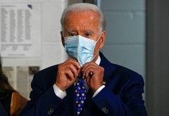 Democraic presidential nominee Joe Biden puts on a mask in Wilmington, Delaware in July. (Photo by Andrew Caballero-Reynolds/AFP via Getty Images)