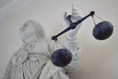 Lady Justice holds her scales. (Photo credit: LOIC VENANCE/AFP via Getty Images)