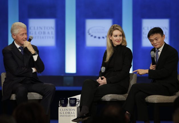 Former US President Bill Clinton and Theranos Founder and CEO Elizabeth Holmes listen as Alibaba Group Executive Chairman Jack Ma speaks during the Clinton Global Initiative annual meeting in New York on September 29, 2015.