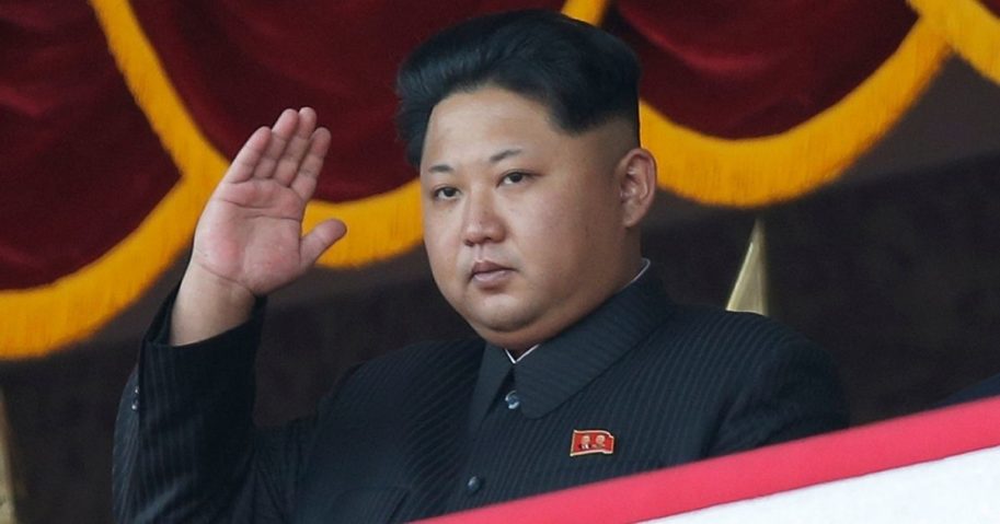 Kim Jong Un gestures as he watches a military parade